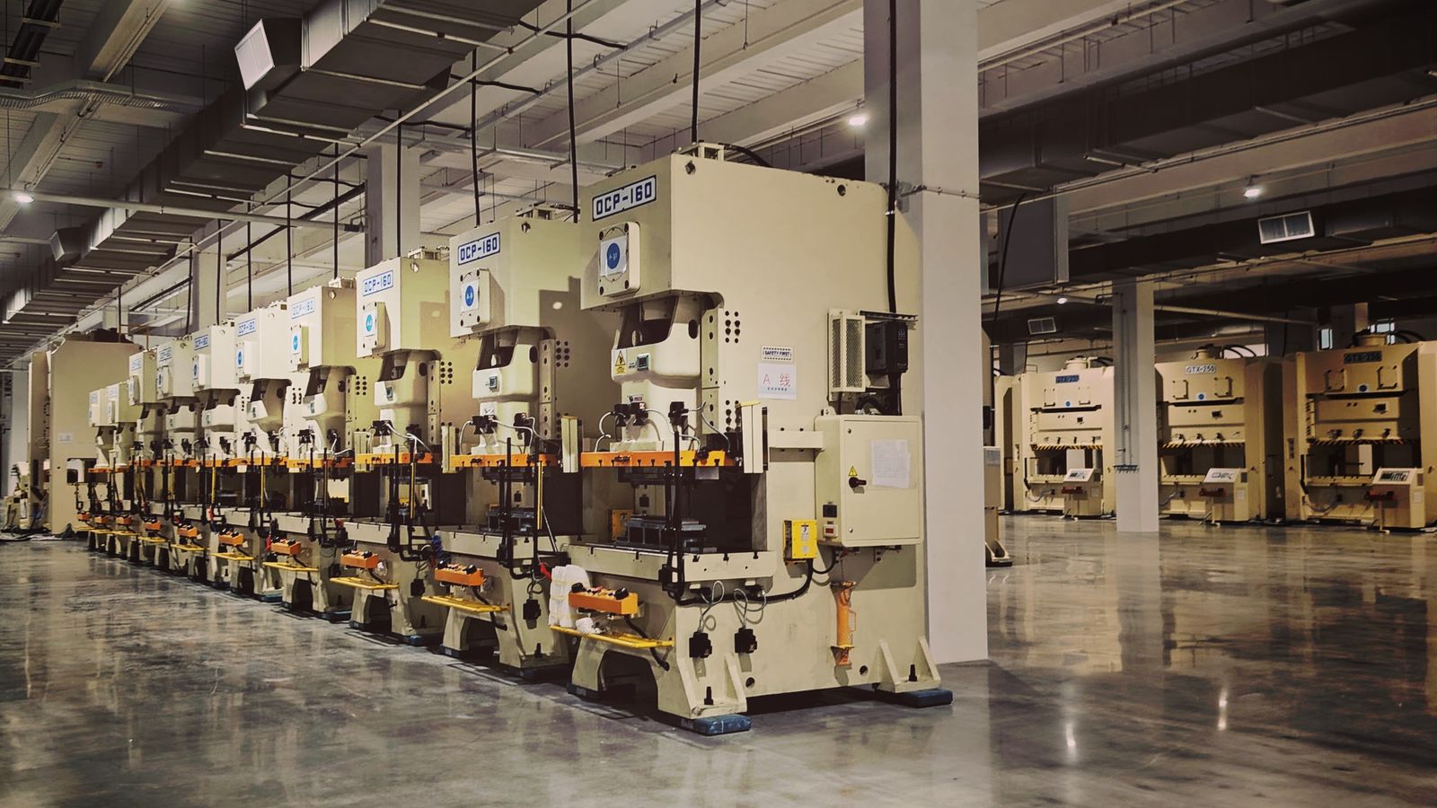 Row of industrial press machines on a factory floor